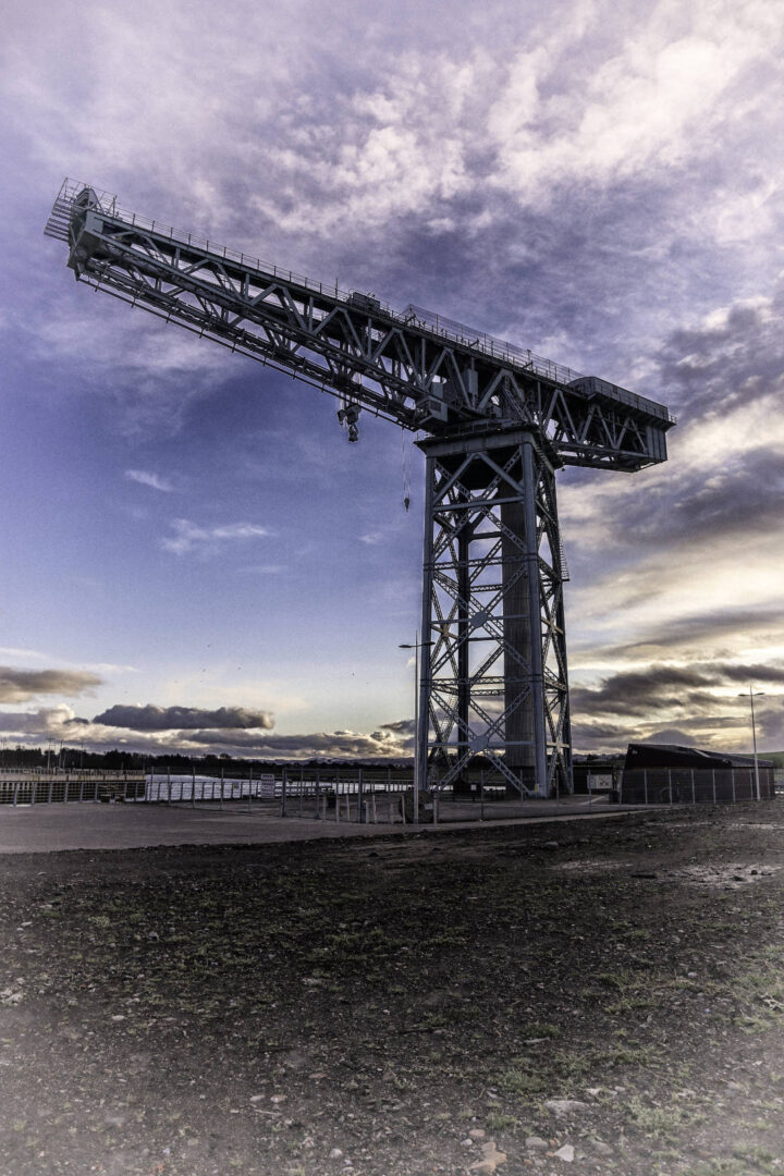A dramatic photograph of the Finnieston Crane at dusk.